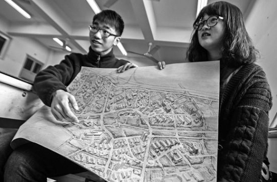 昨天上午，在漫画柜
，手绘图的作者郭龙(左)和何菡丹(右)在展示他们的创作手稿。 记者 姚卡/摄